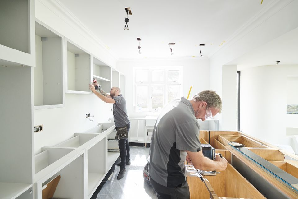 Workers remodeling a kitchen
