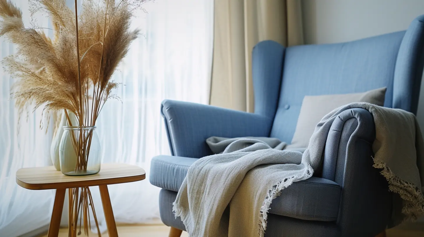 cozy reading nook with a denim blue armchair, a soft gray throw, and a light wood side table